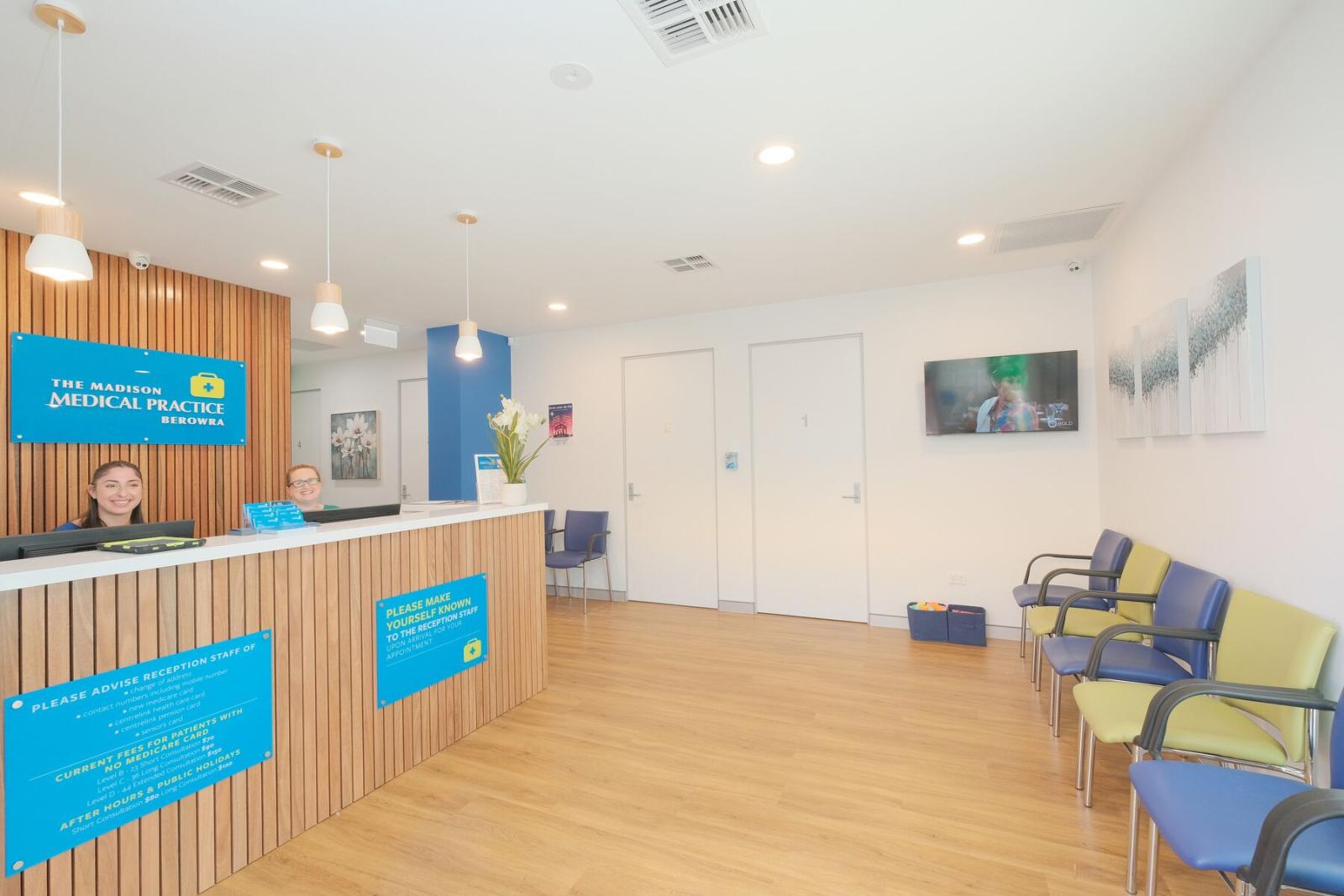 Modern medical practice reception area with welcoming staff and comfortable seating