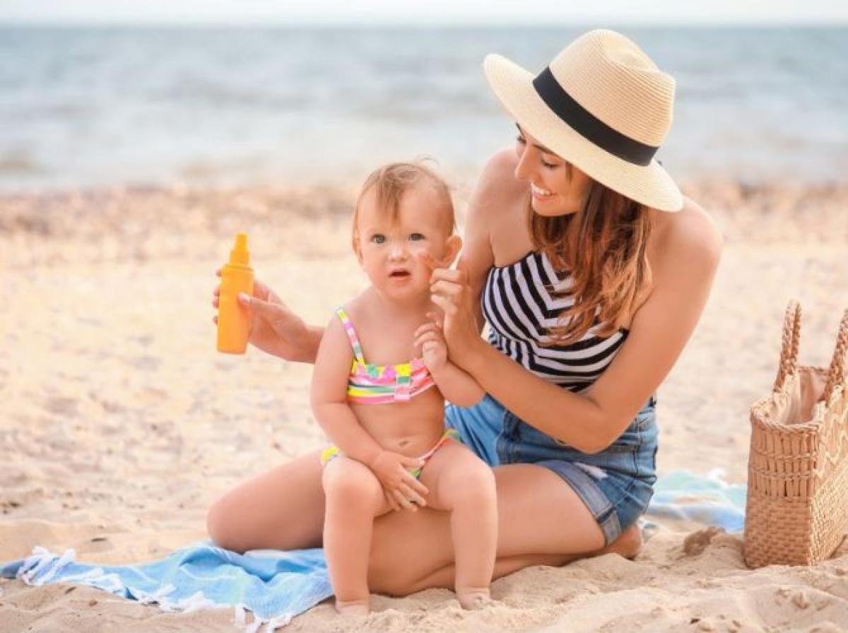 Mother applying sunscreen to toddler on beach for sun protection